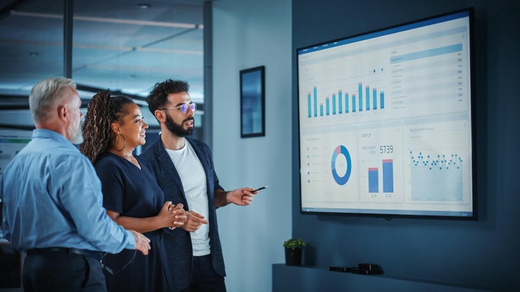 People viewing a screen with data and analytics